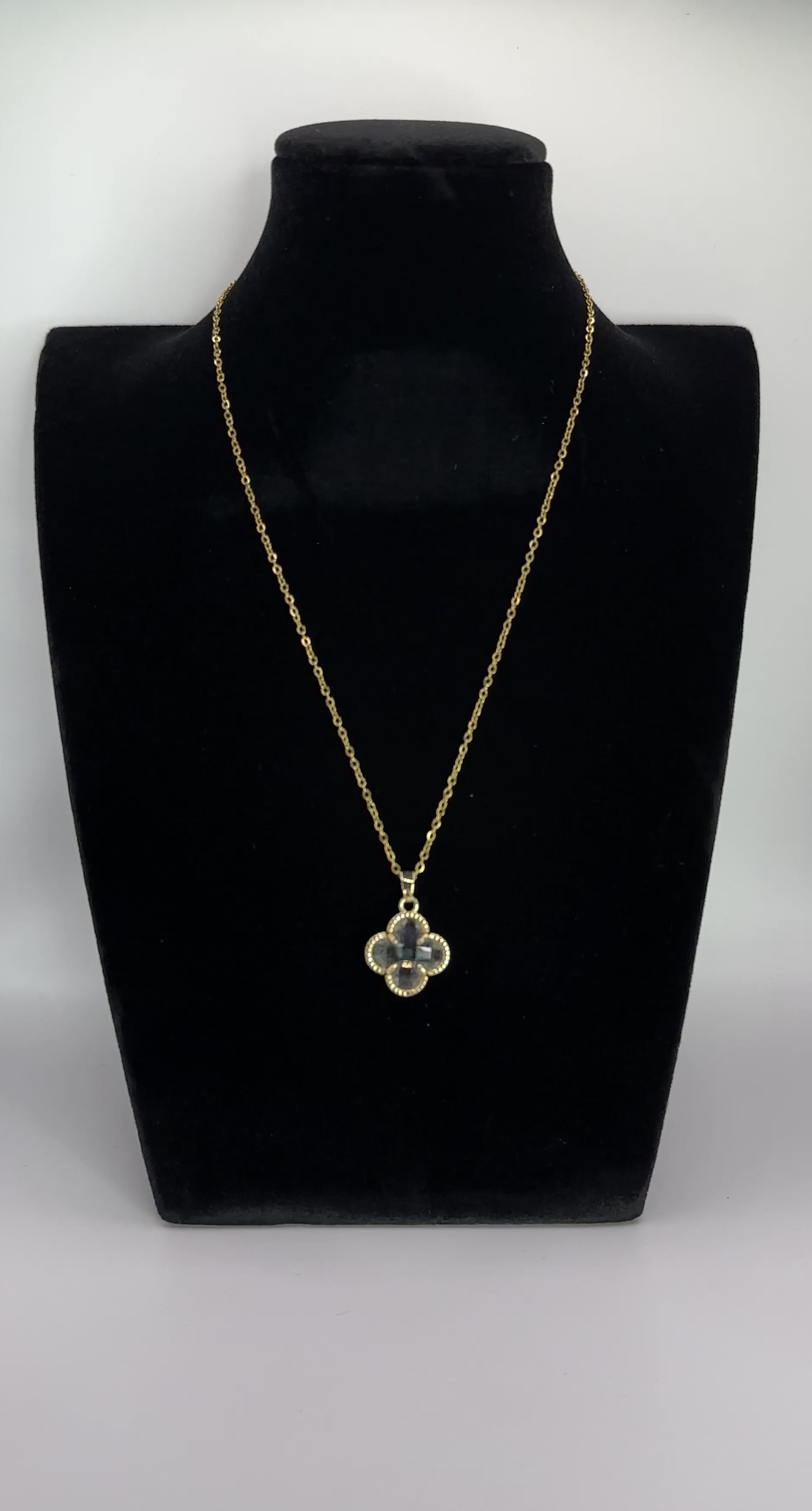 Close up front view of elegant 18K gold plated designer-inspired Van Cleef crystal clover necklace.  Lightweight and versatile design, with long lasting, waterproof plating perfect for any occasion, from casual outings to formal events. 